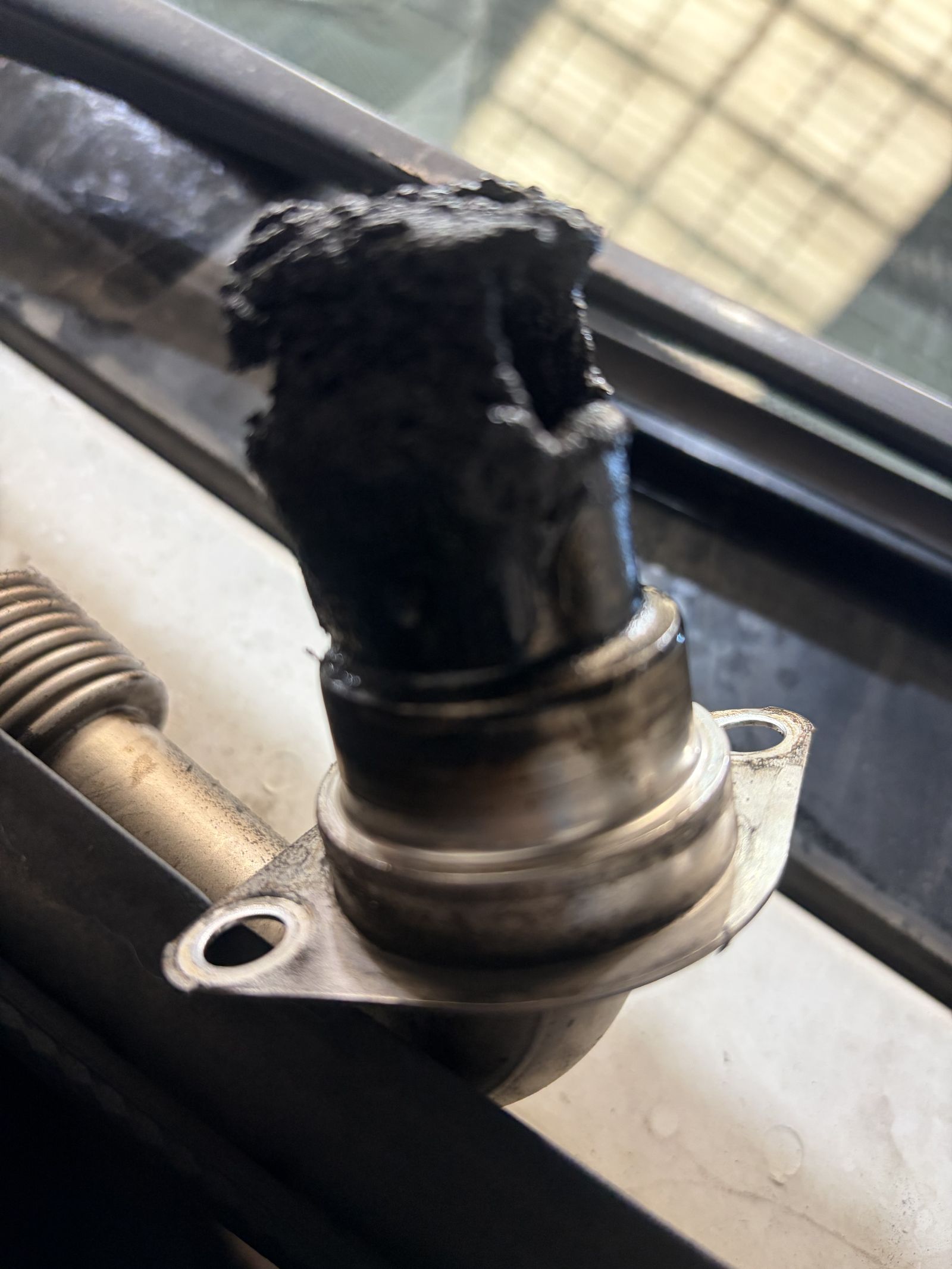 Oil-contaminated EGR pipe pulled from a Mercedes diesel during emissions diagnosis
