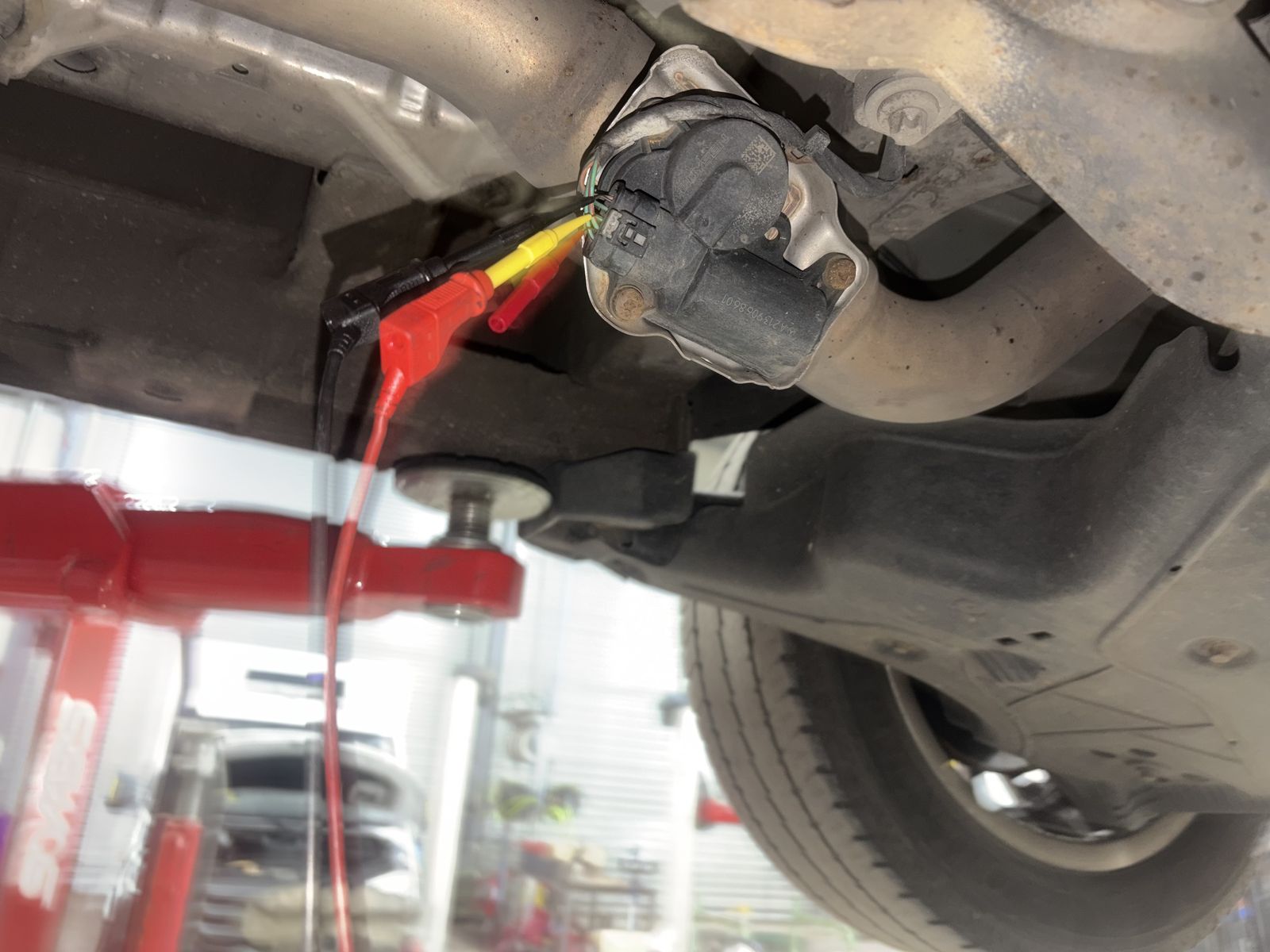 Multimeter probes inserted to measure exhaust pulse pressure on a Mercedes Sprinter