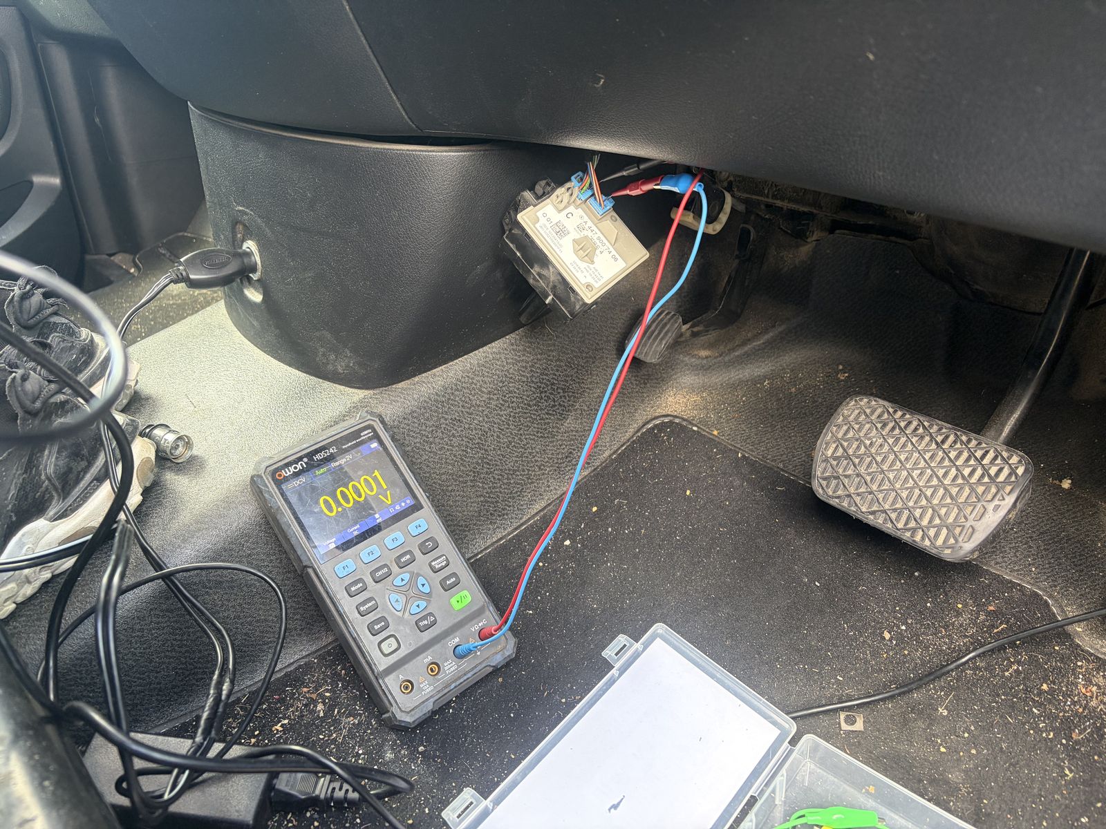 Multimeter probing a sensor circuit on a Mercedes engine bay during live testing