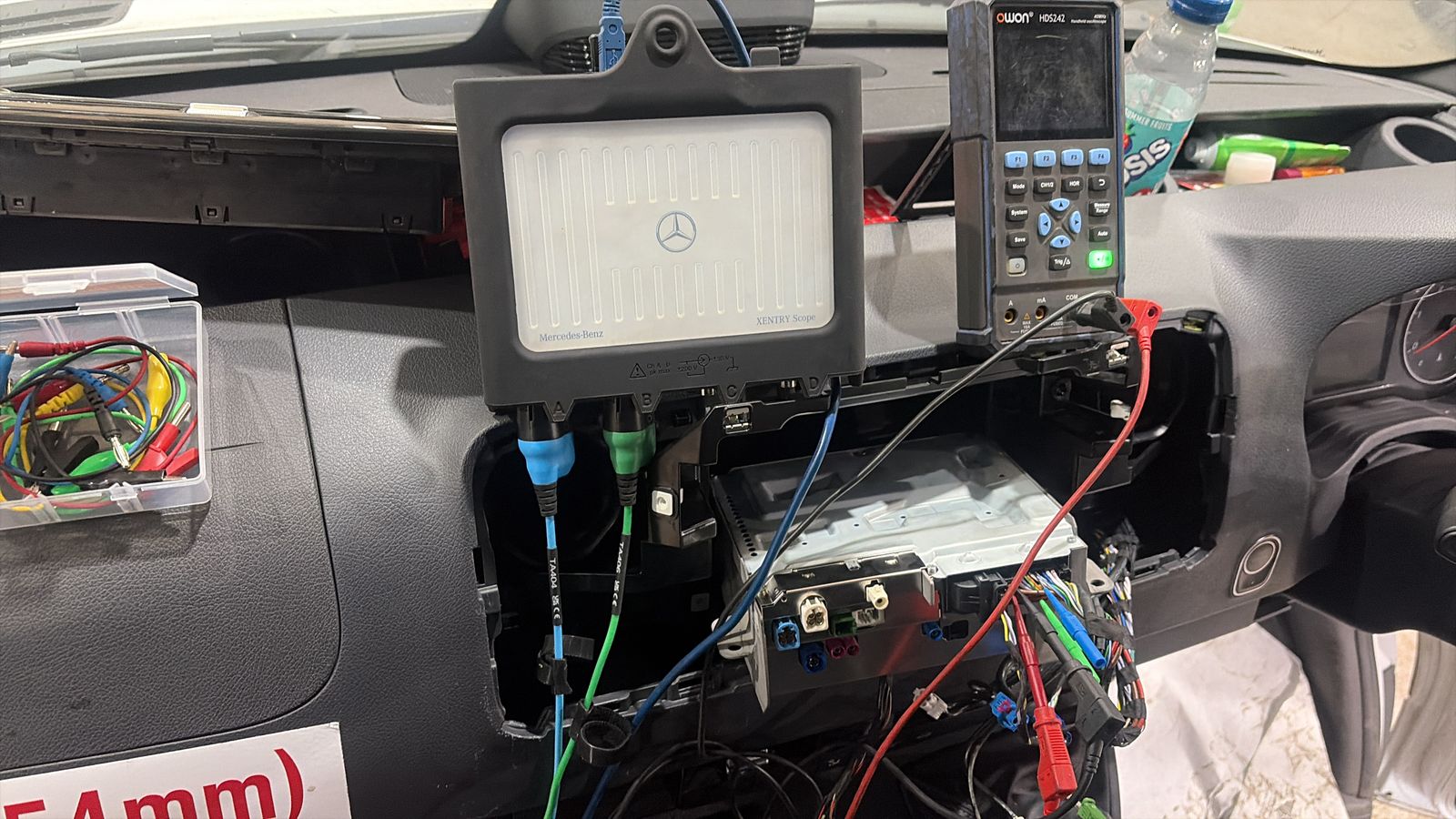 Picoscope and multimeter set up on a Mercedes for live signal capture during diagnosis