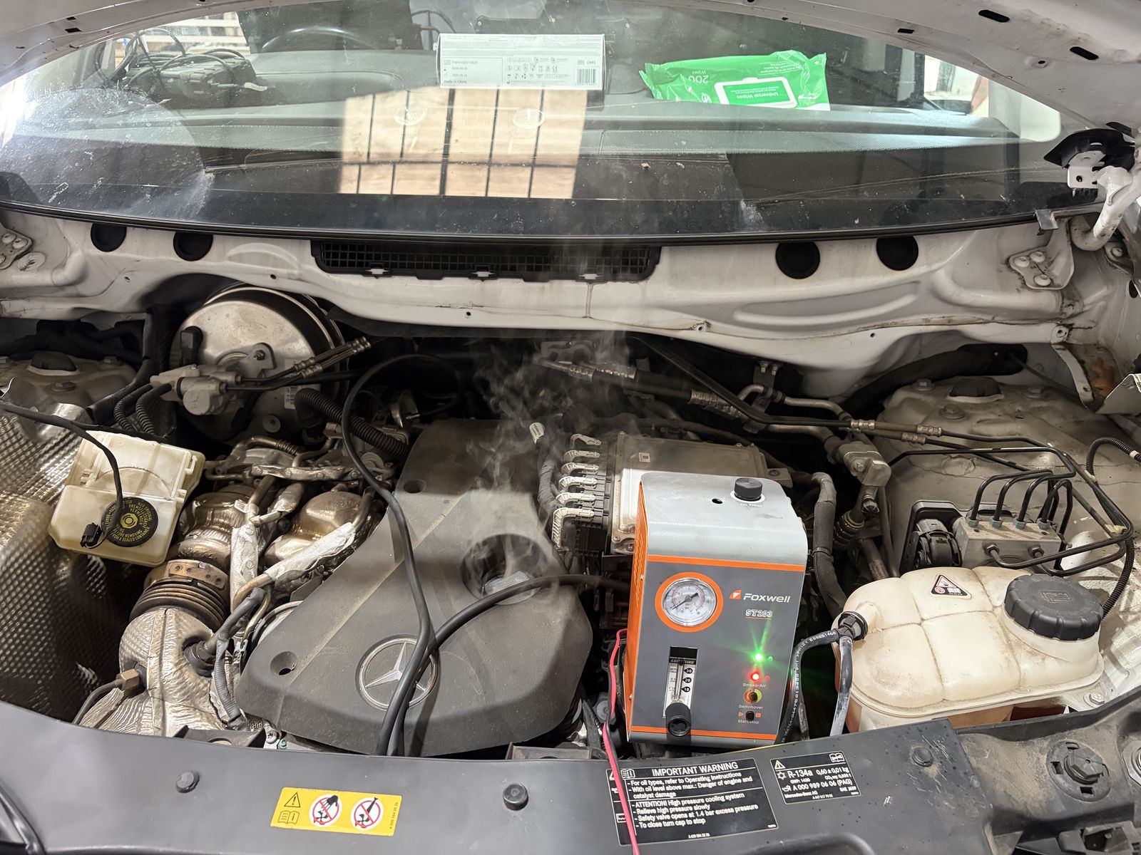 Smoke machine leak testing the intake on a Mercedes diesel during diagnosis