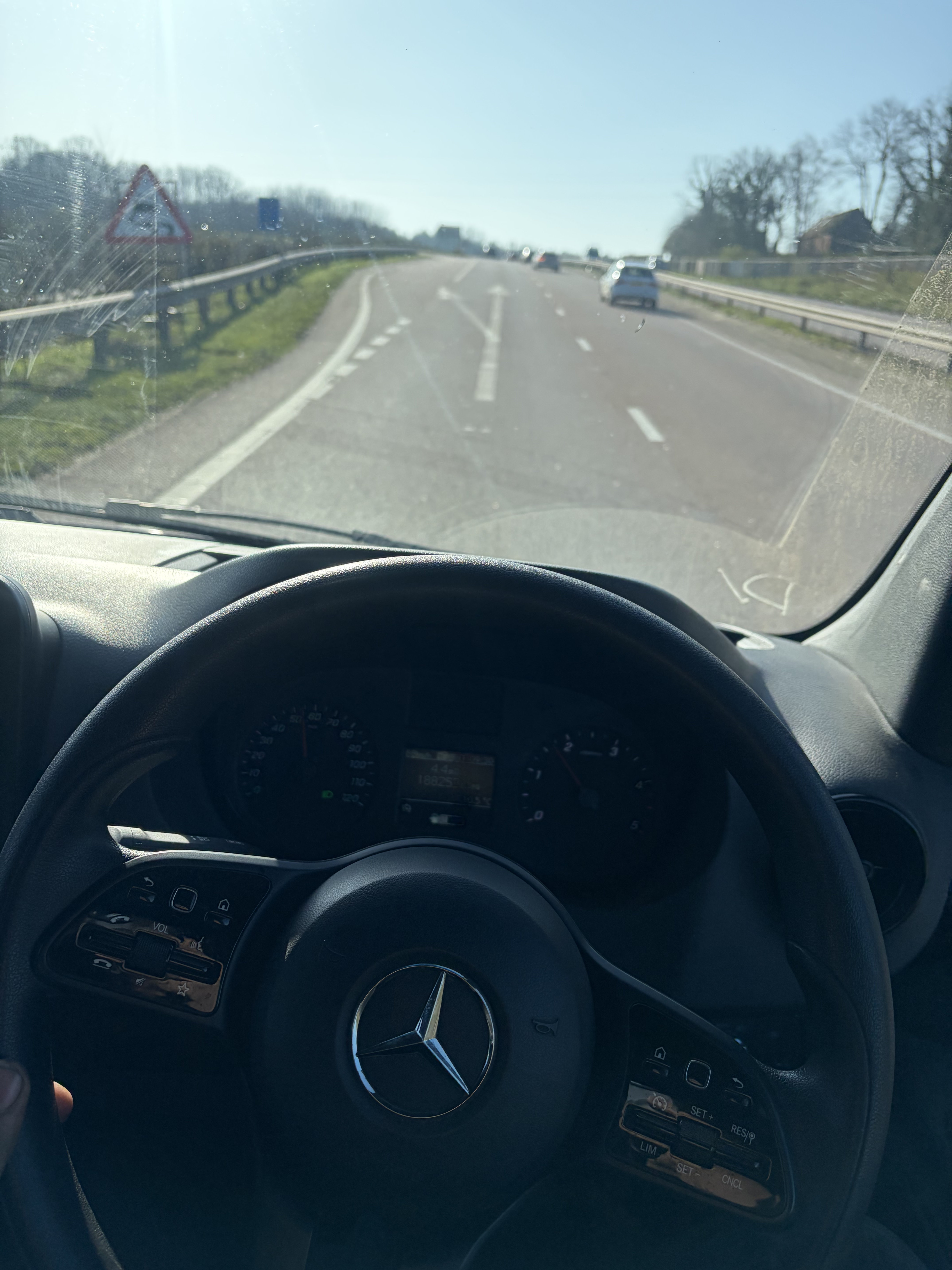 Driver's view from a Mercedes Sprinter cab on the road