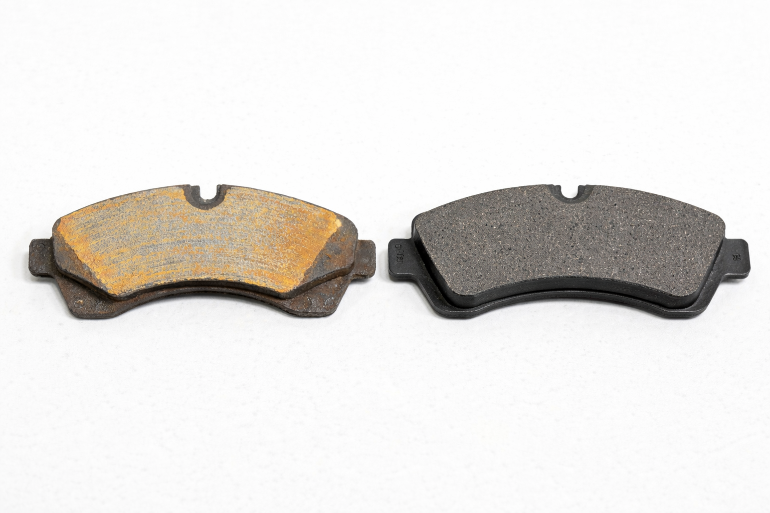 Worn brake pad next to brand new pad on Mercedes Sprinter