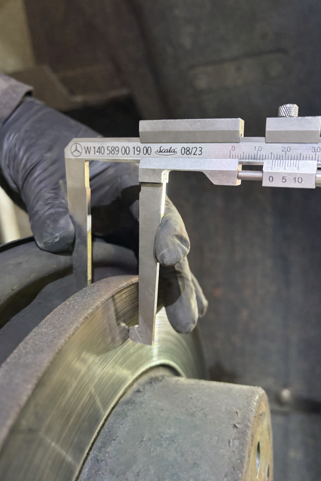 Digital vernier caliper measuring brake disc thickness on Mercedes Sprinter