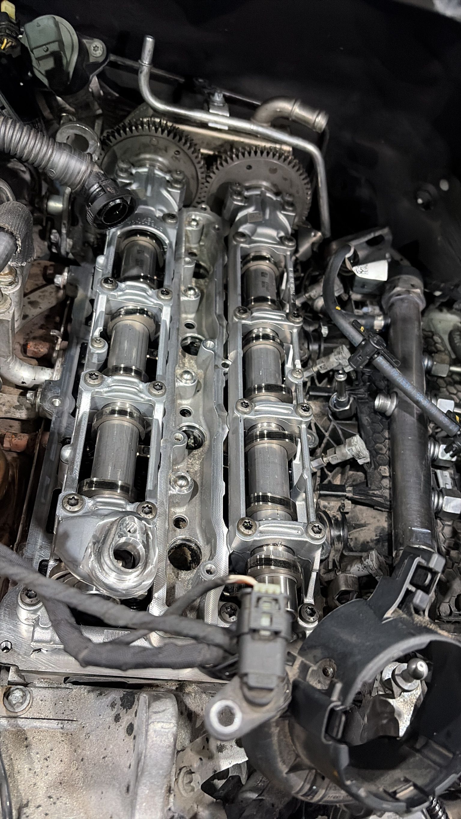 Dual overhead camshafts and timing gears exposed during engine strip