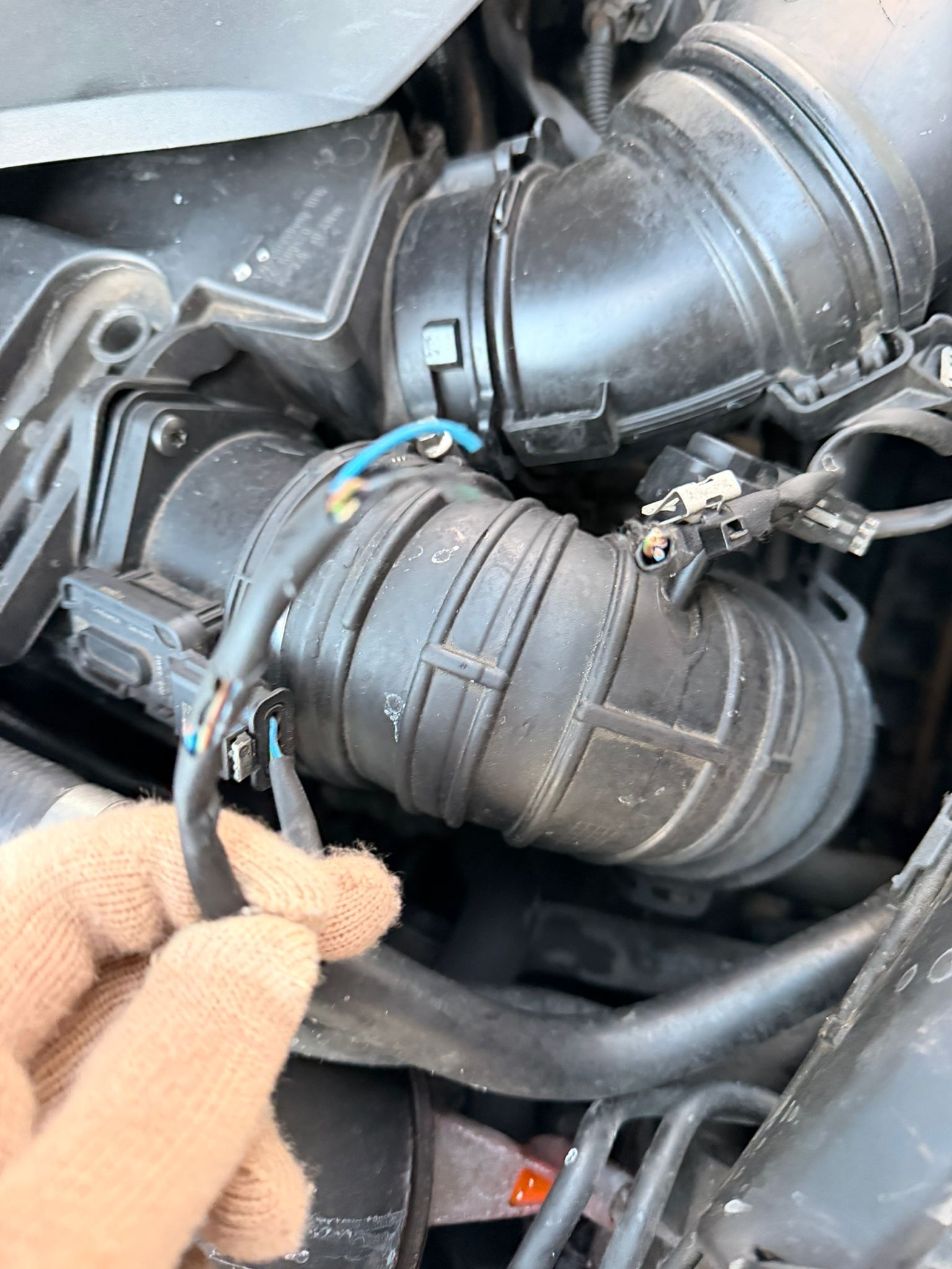 Damaged wiring loom in Sprinter engine bay with frayed cables