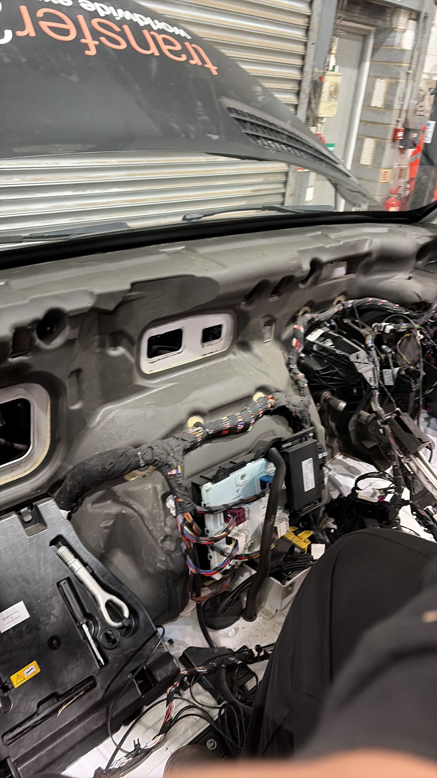 Sprinter interior stripped to firewall showing exposed wiring and ECU