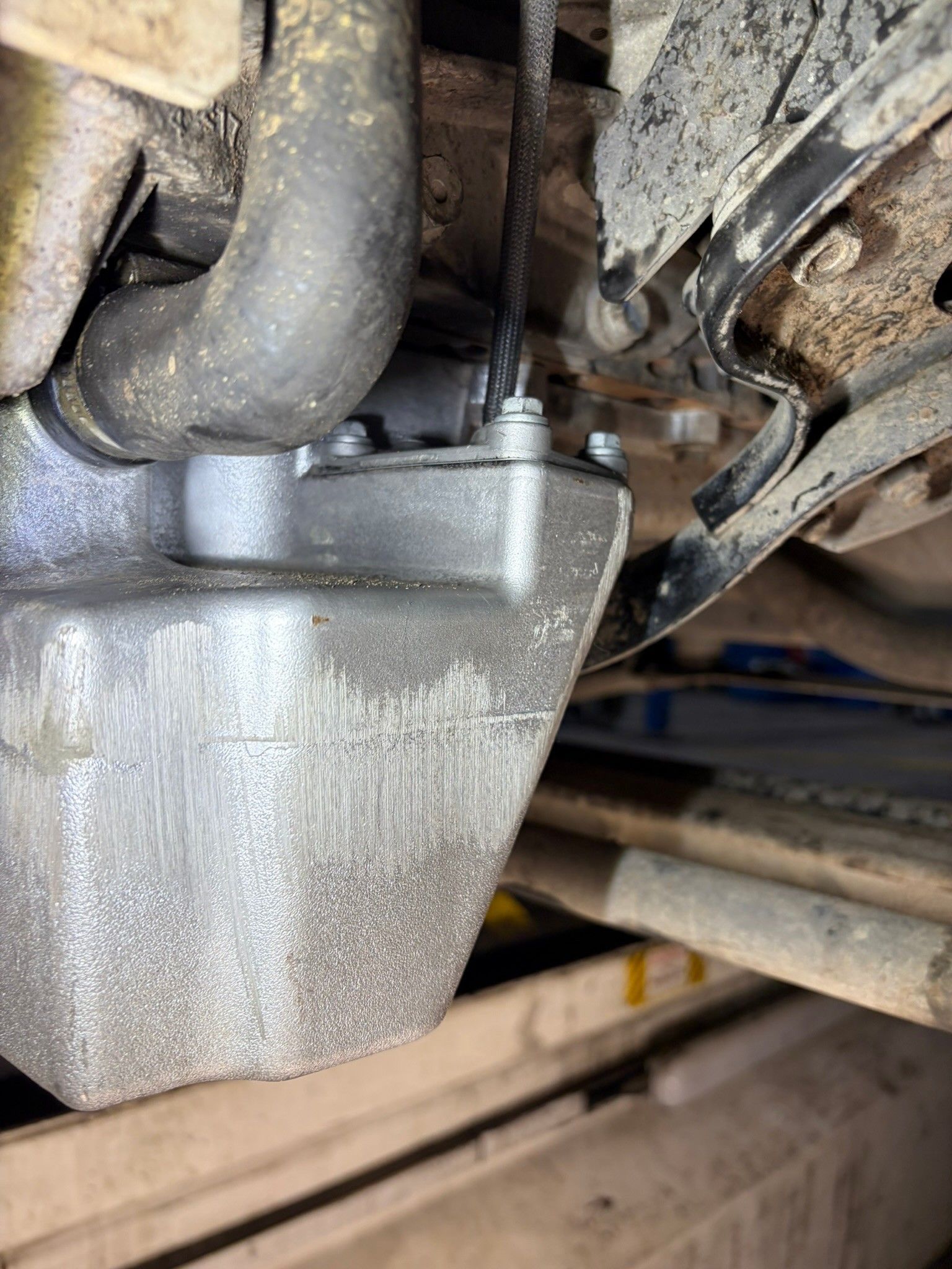 Undercarriage engine oil pan with scuffing damage