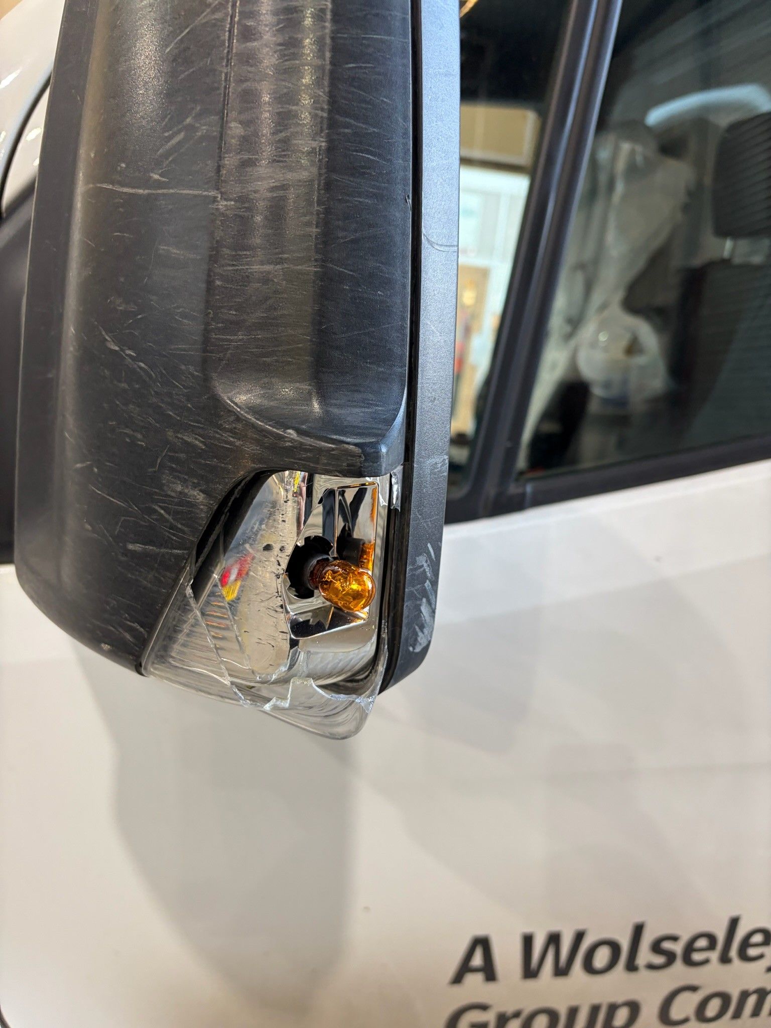 Scuffed wing mirror on white Mercedes Sprinter with shattered indicator