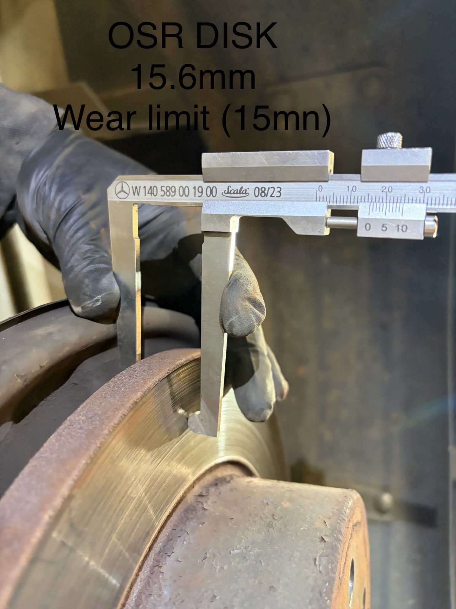 Mercedes vernier caliper measuring worn brake disc at 15.6mm