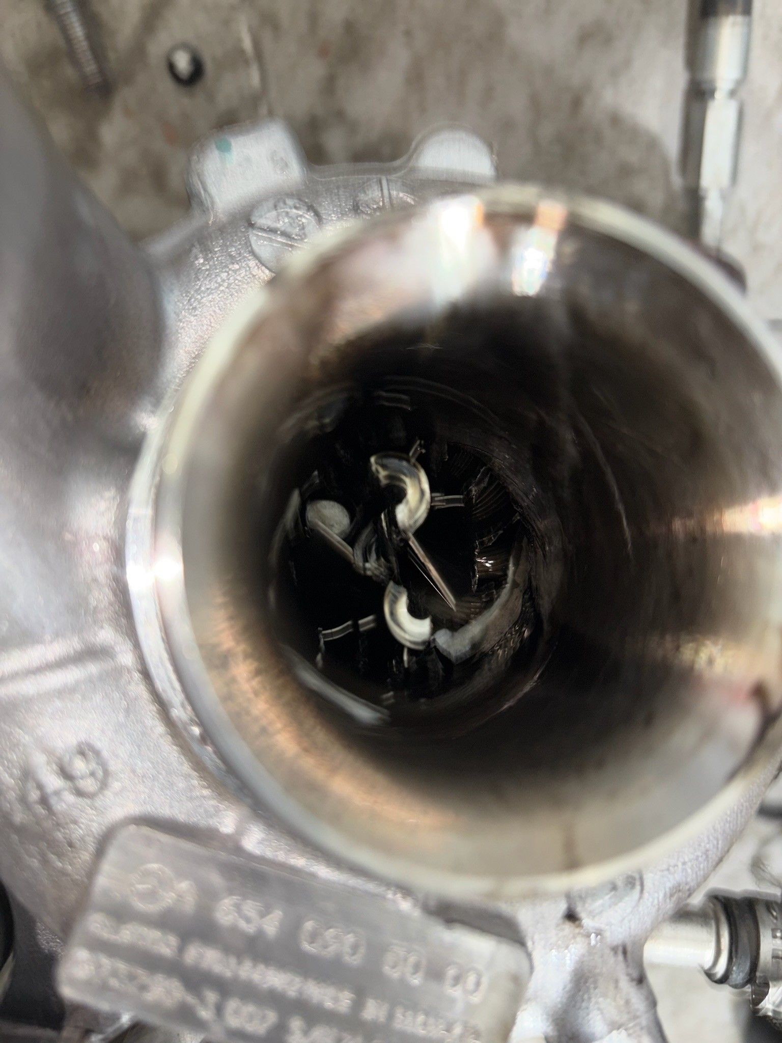Damaged turbocharger with sheared metal inside housing