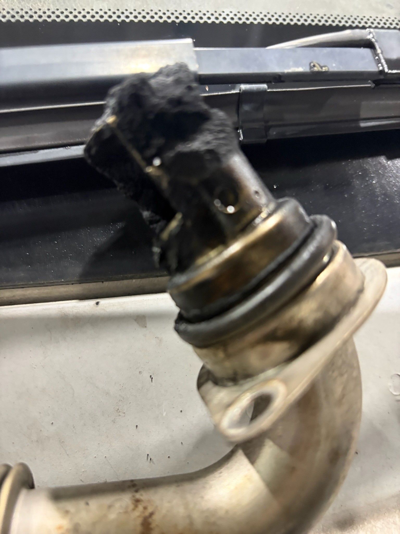 Fouled EGR pipe with thick carbon soot on white Sprinter