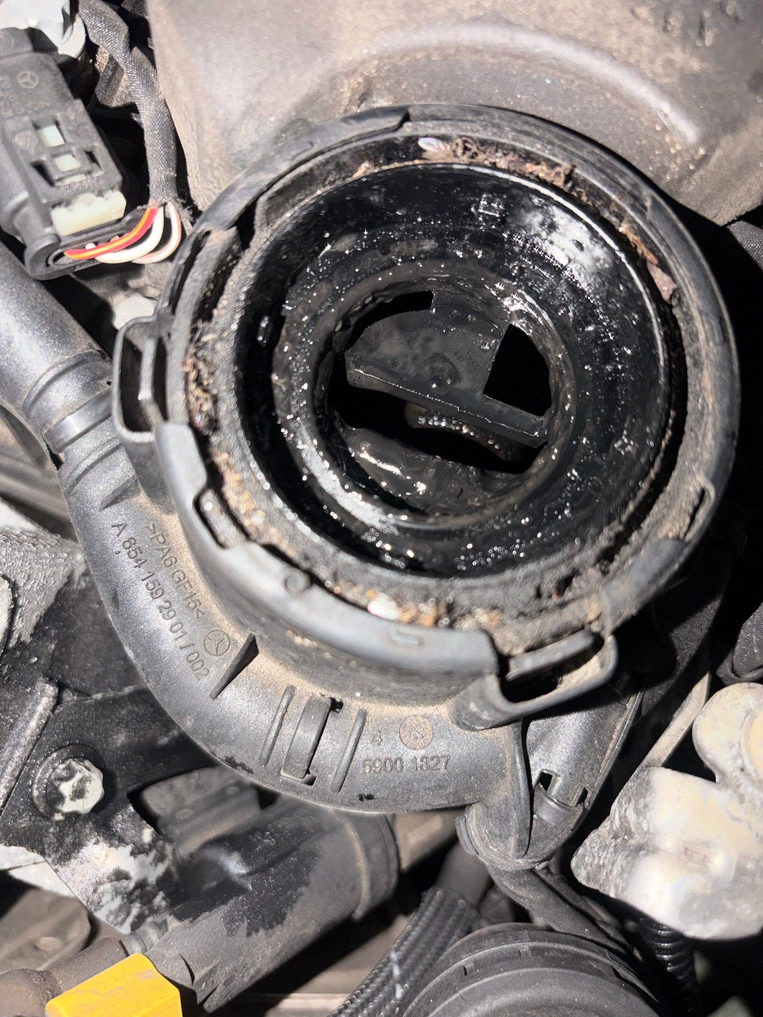 OM654 engine component with Mercedes part number and oil residue