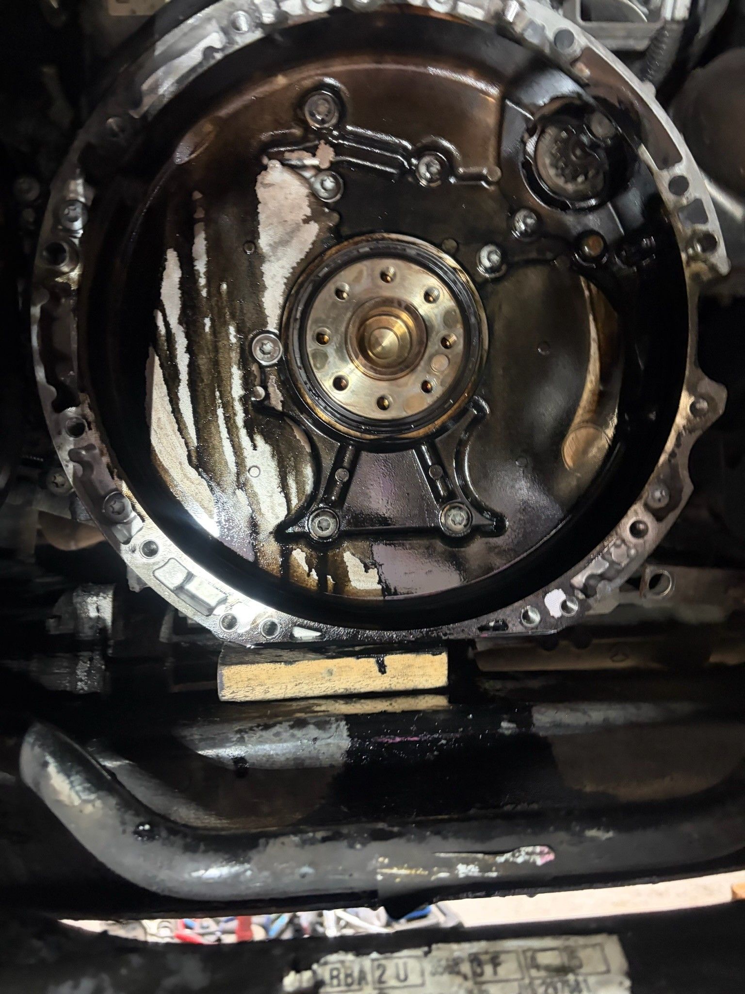 Rear main seal area with oil leak visible after flywheel removal