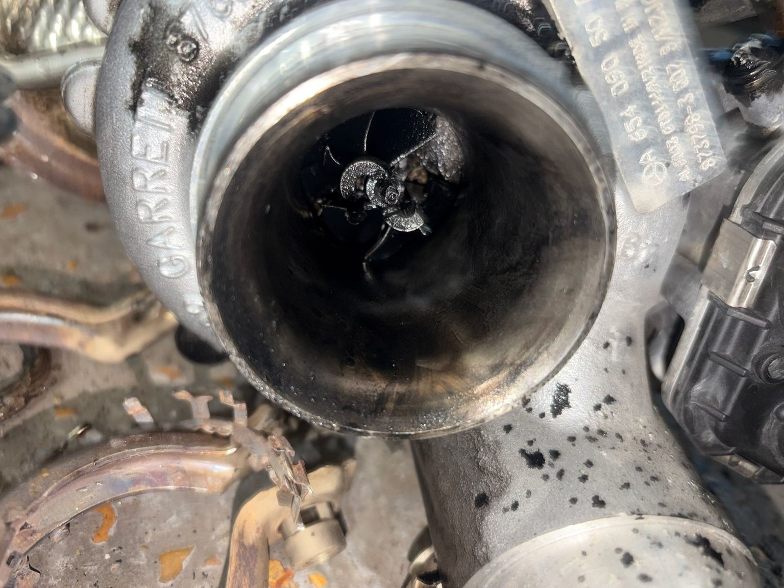 Garrett turbocharger removed showing soot build-up inside housing