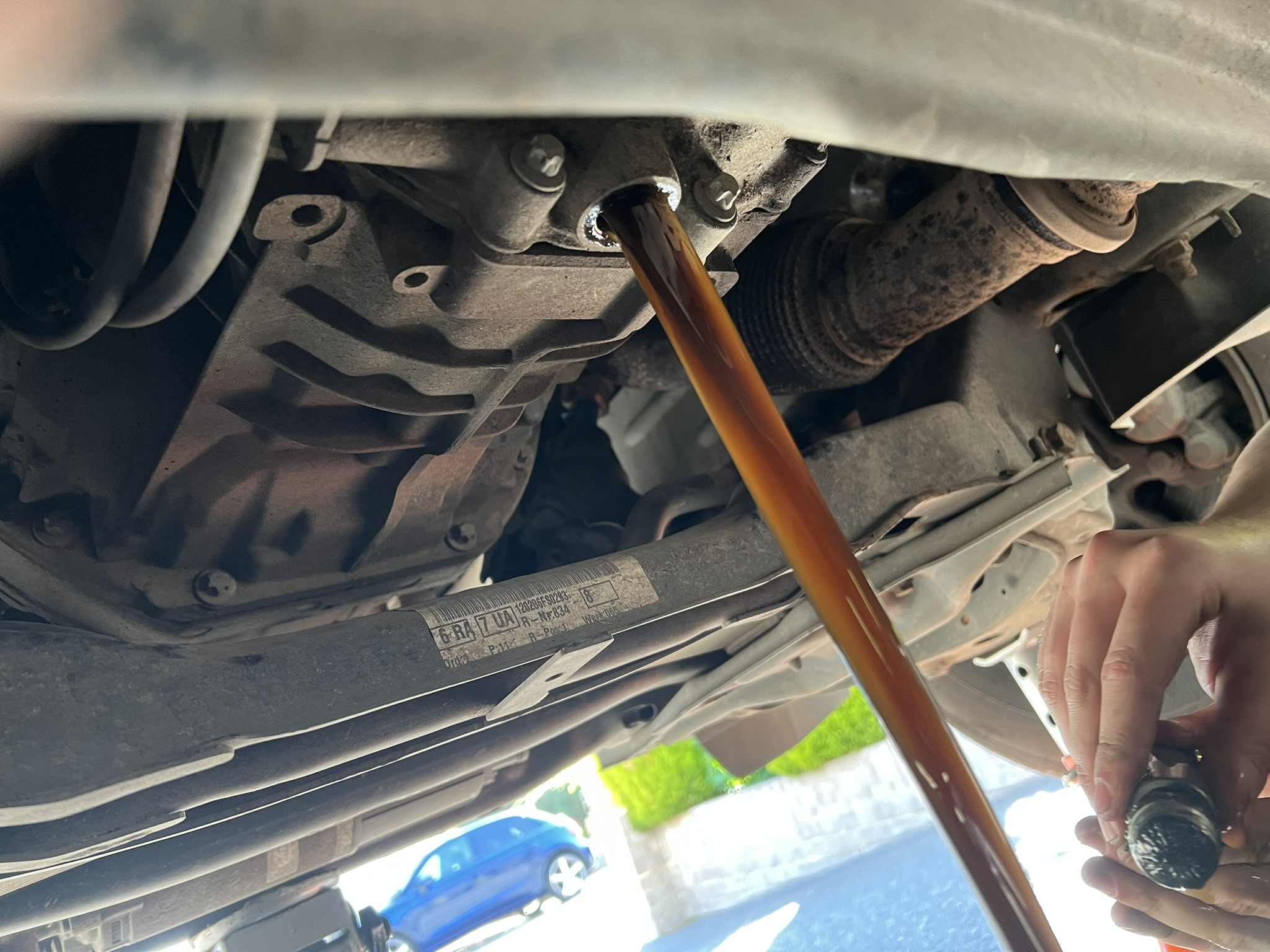 Gearbox oil being drained during transmission fluid service