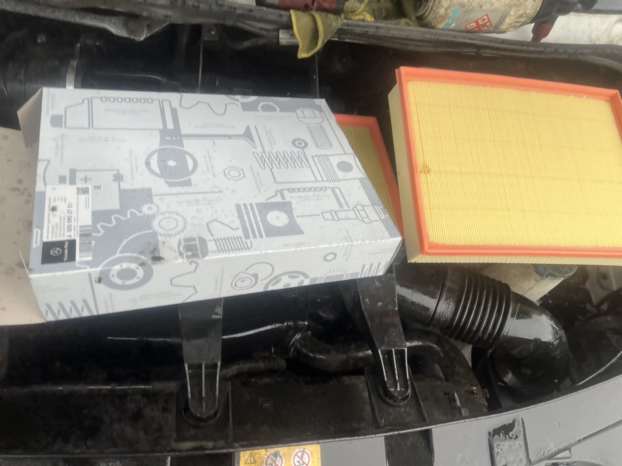 Genuine Mercedes filter box with new filter beside it