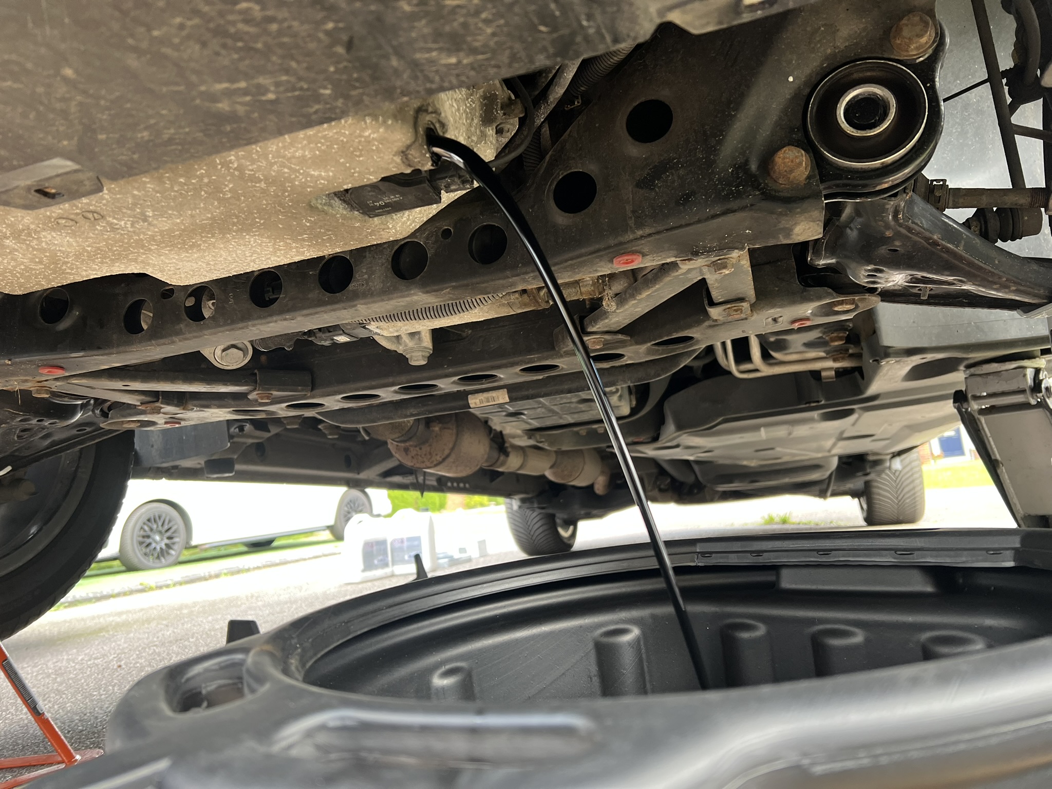 Old engine oil draining from sump during service