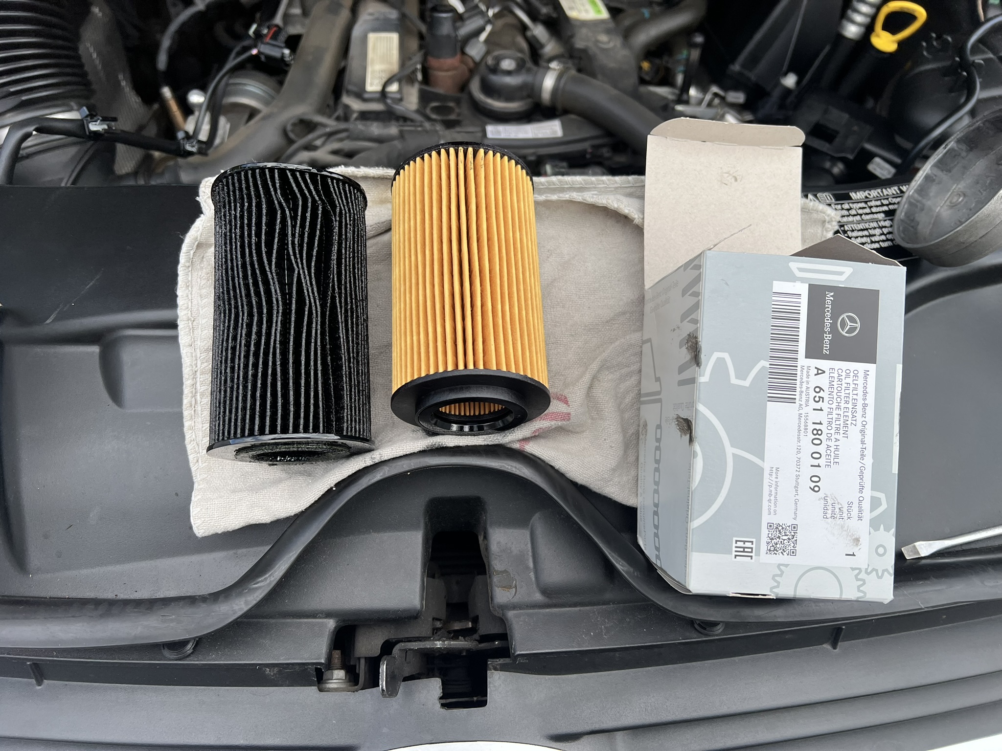 Old and new Mercedes oil filters side by side
